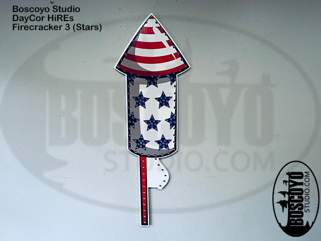 Firecracker-shaped product with American flag design on a white background, featuring Boscoyo Studio branding.